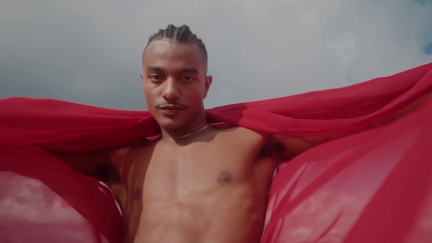 A man with a red cape billowing behind him