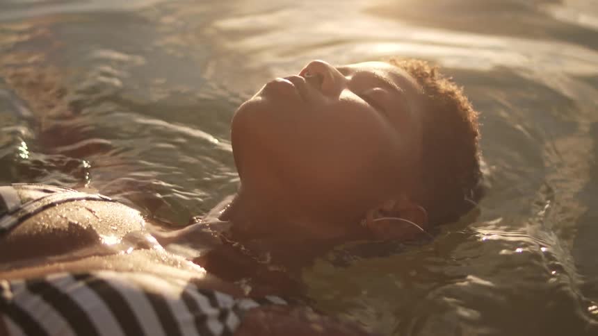 Woman floating in calm waters