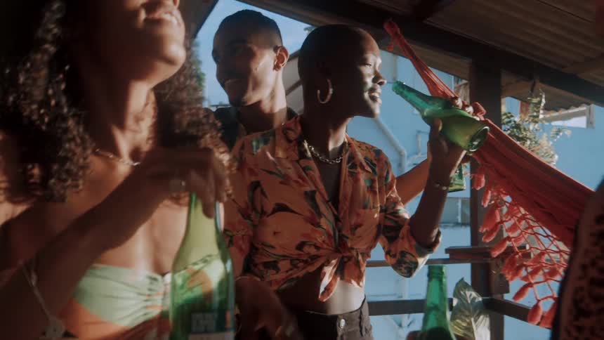 Group of black friends drink and party at a balcony during daytime