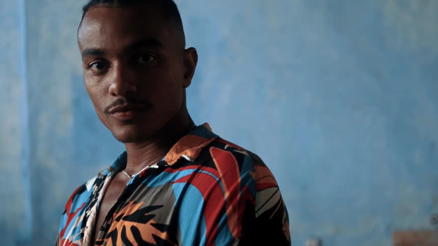 A man looks at the camera