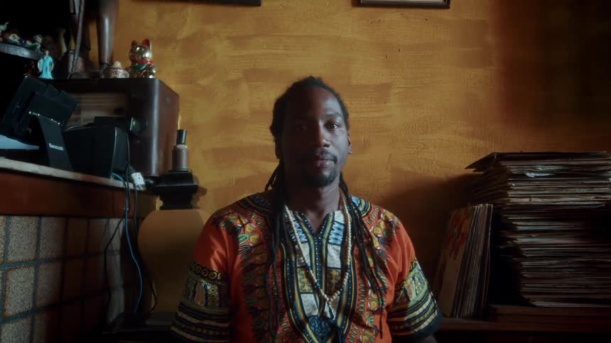 Man in traditional attire facing camera