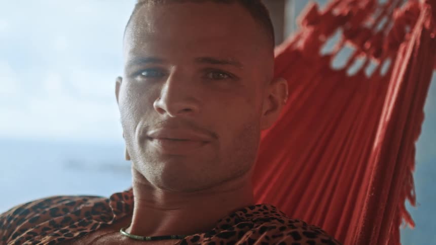 A man is relaxing in the hammock