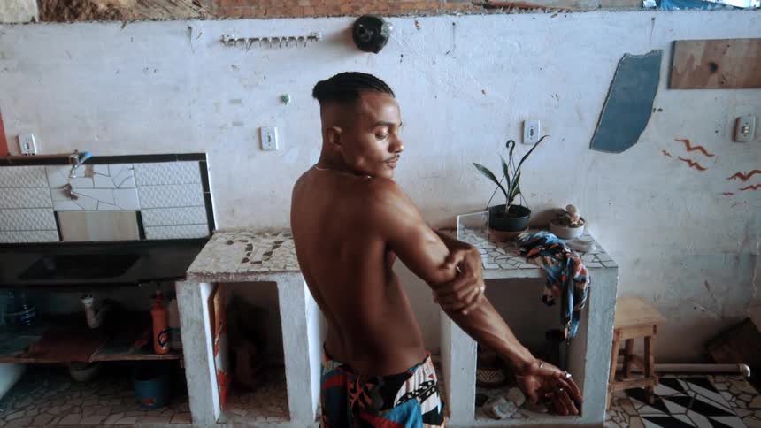 A man rubs his shoulder and arm