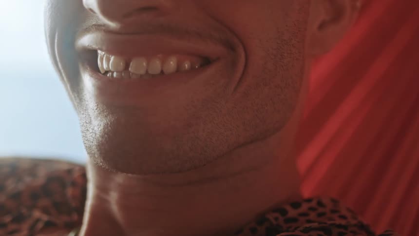 A man laughs in the hammock