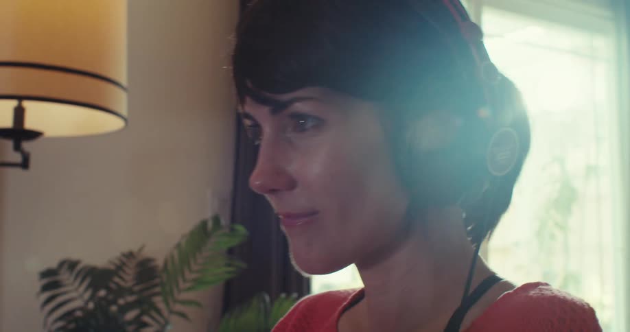 A woman puts on headphones