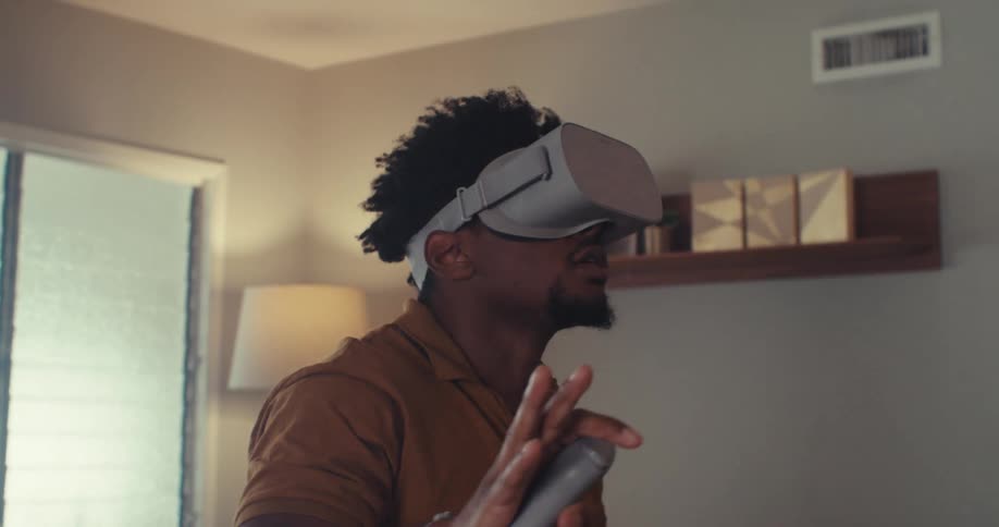 The man is looking around with virtual reality headset on