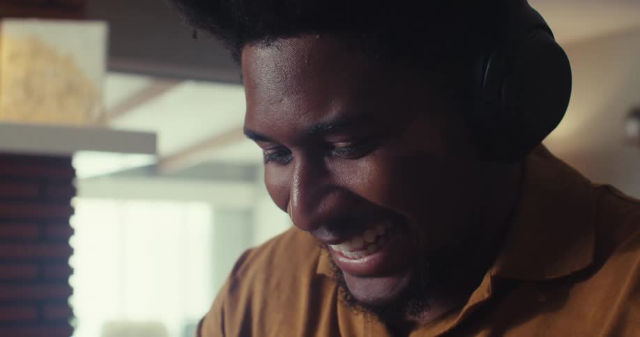 Man with headphones talking smiling