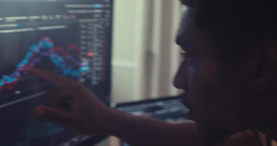 Man contemplates a graph displayed on his computer while sitting at home