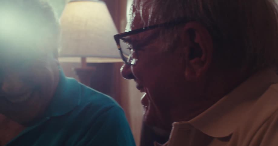 A man and woman chat and smile