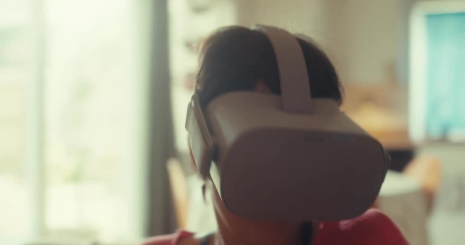 The woman is waving the controller and looking around