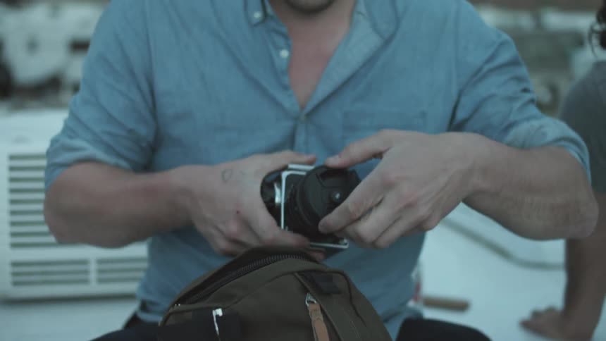 A person opening a backpack