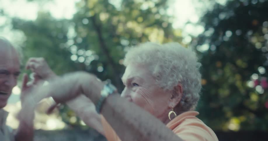 An elderly couple dance