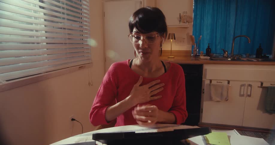 Woman expresses gratitude while talking to someone using a tablet