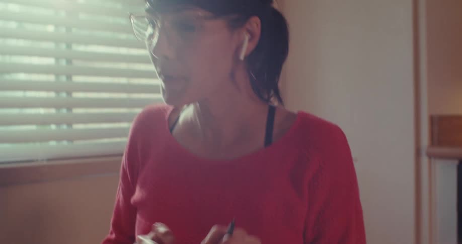 Woman highlights a document while working from home