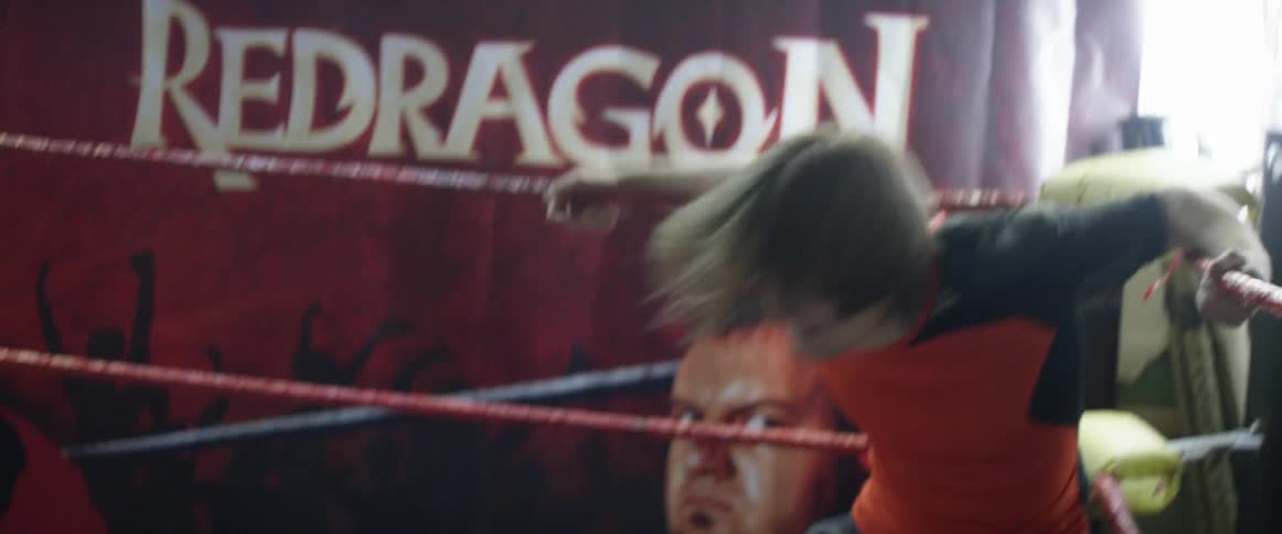 Two wrestlers are battling in the squared circle