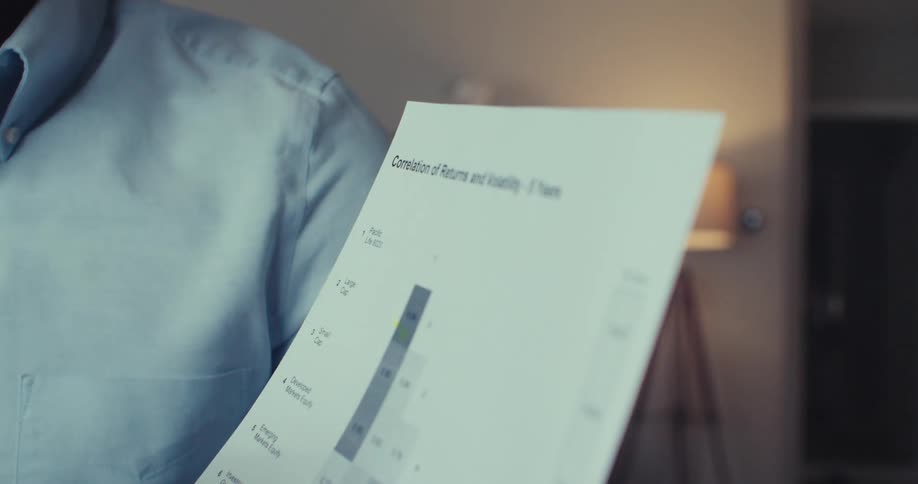 Man talking and holding a sheet of document