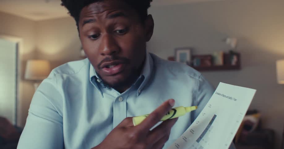 Man highlights chart while explaining in a cozy setting