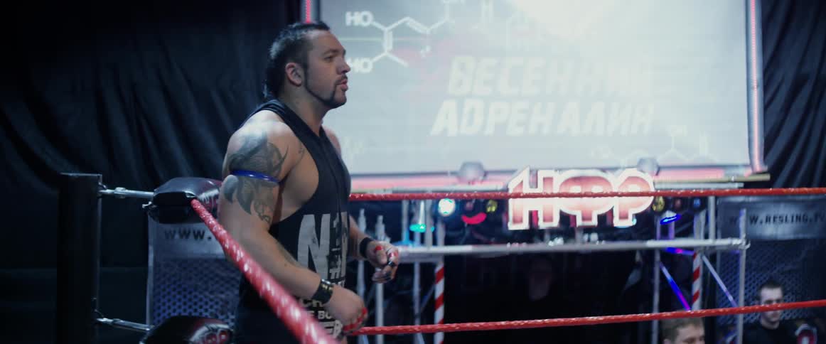 A wrestler hops around in the ring