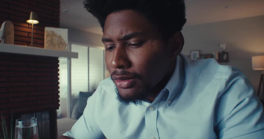 A man gets worried while reading his laptop