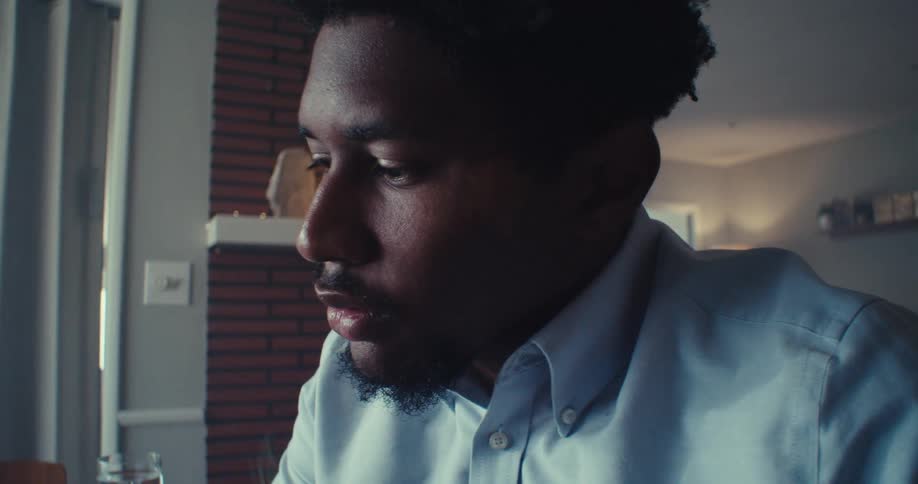 Man in a living room working focused and thoughtful