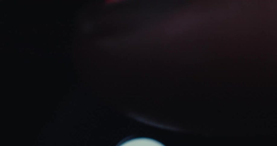 Close up of a person clicking the heart icon while scrolling through a social media app on a digital device