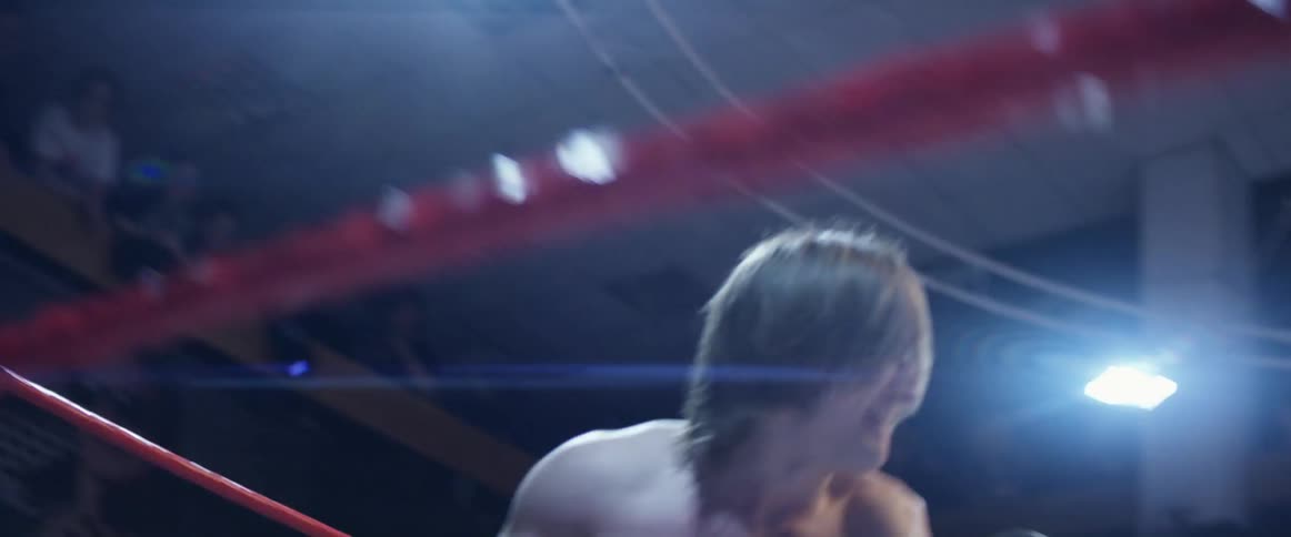 Two wrestlers fighting in a ring