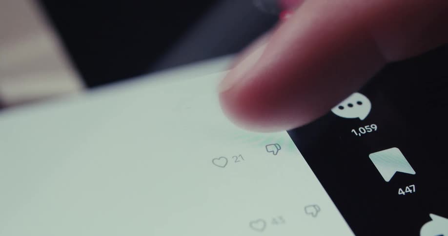 A finger taps at a phone