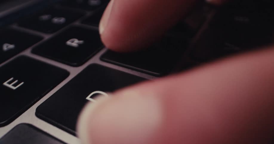 Close up of a person typing on a laptop keyboard