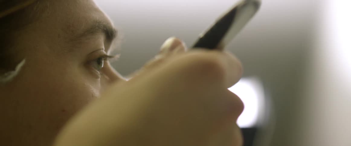 A man shaves his face with a razor