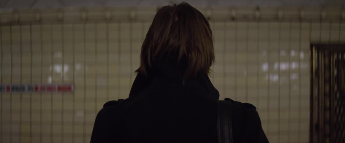 A person is waiting for a train on a platform