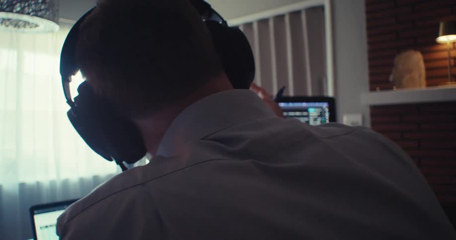 Man on an office video call analyzing stock charts on a computer