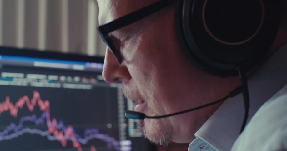 Man with headset focuses during a computer call