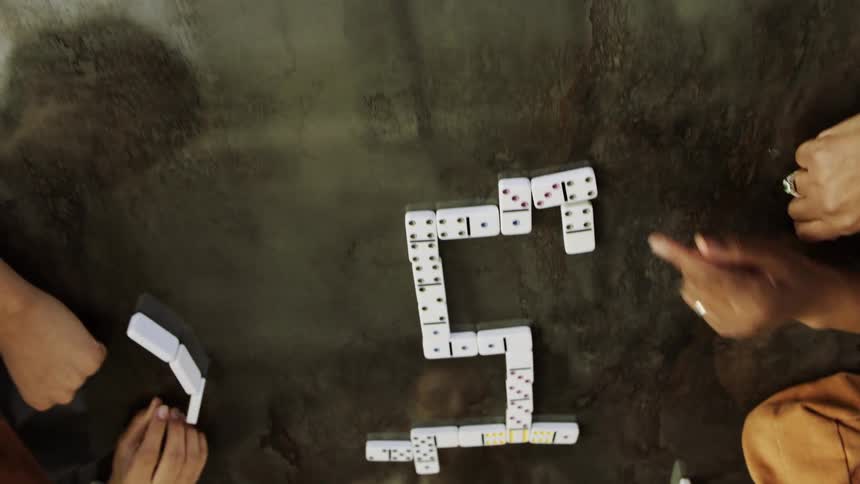 Friends play dominoes together