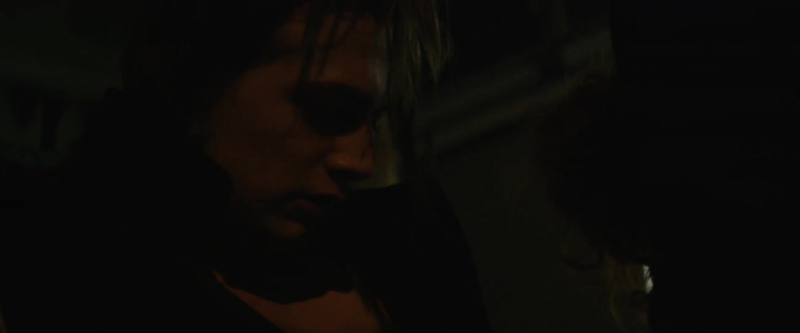 Two people talking in a dim room
