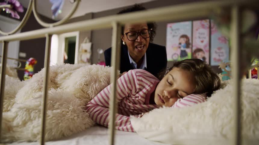 A mother wakes her daughter up