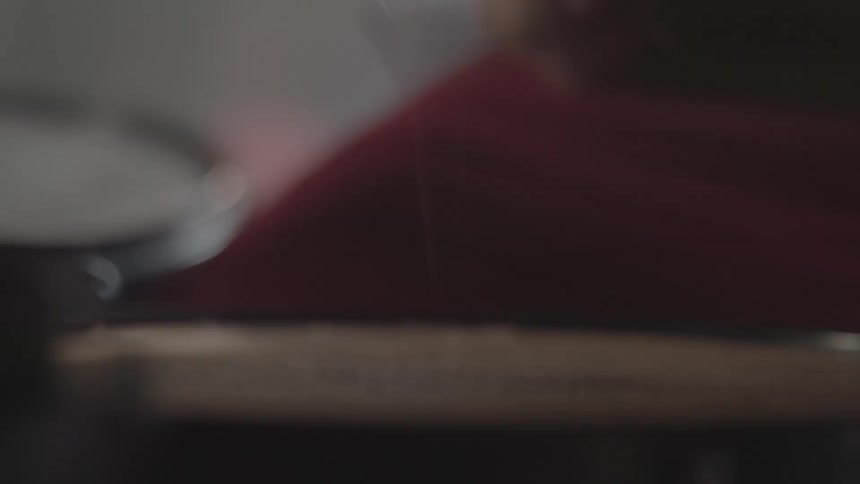 Close up of a drum surface as a drummer plays continuously