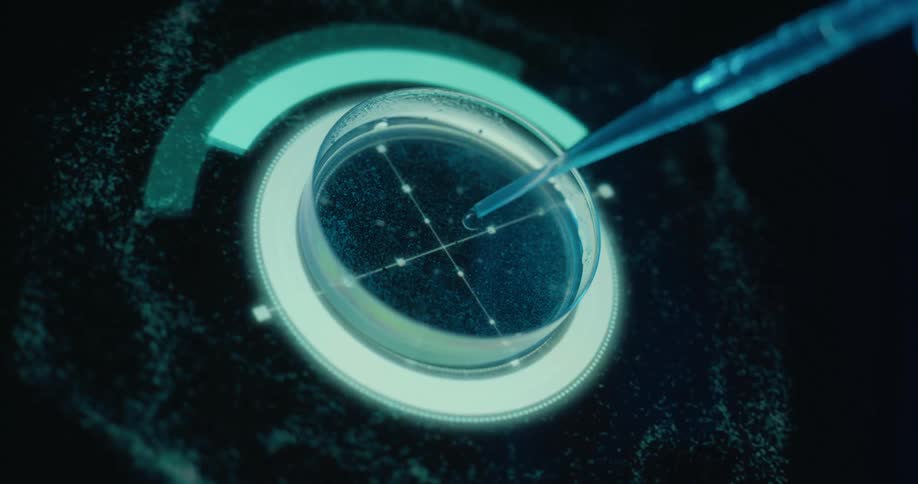 Close up of a liquid sample dropped with a pipette into a petri dish placed on a futuristic screen for analysis