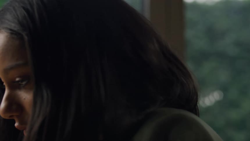A woman tucks her hair behind her ear