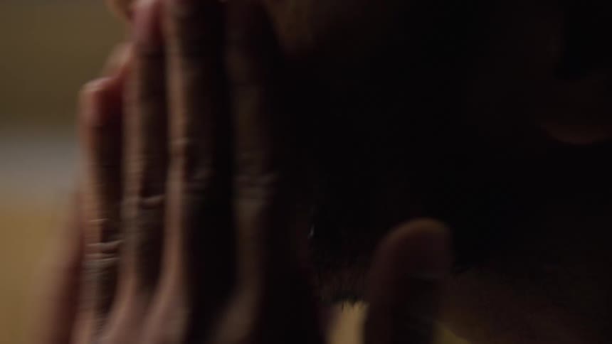 Man coughs and slaps his face before shaking his head and blinking rapidly