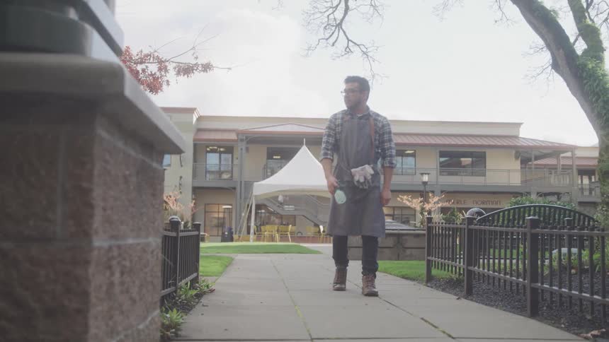 A man walks down a sidewalk