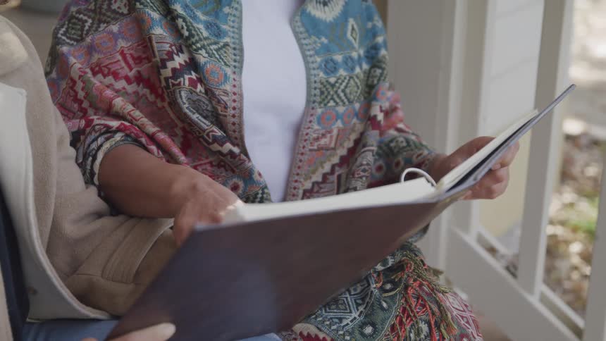 Two women look at a photo album together
