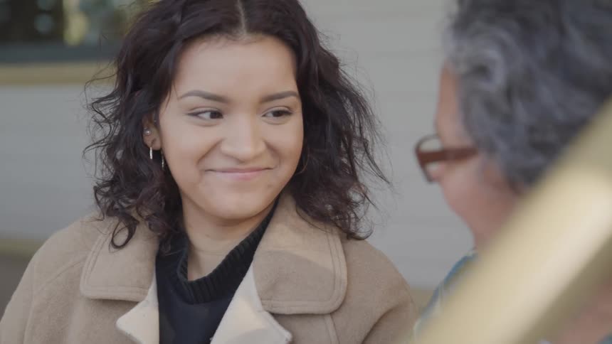 A woman looks at her grandmother and smiles