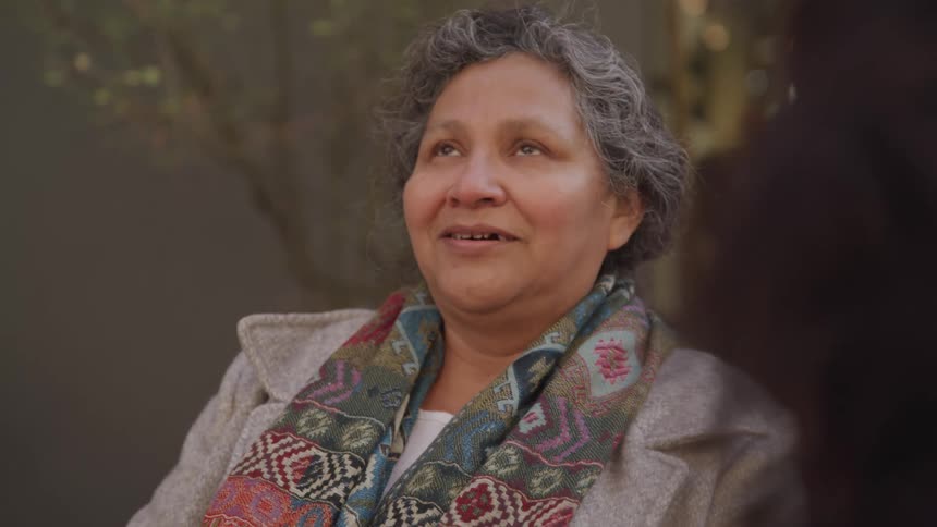 Happy and emotional woman talking to another person