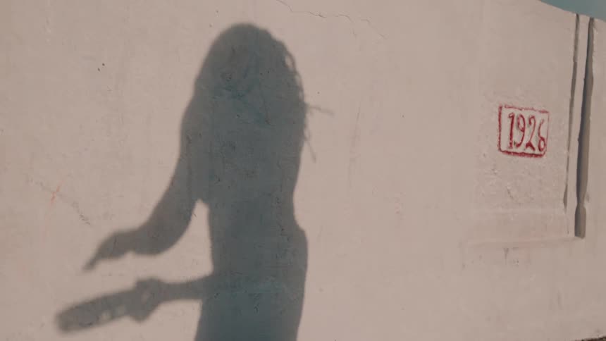 A moving shadow on a wall