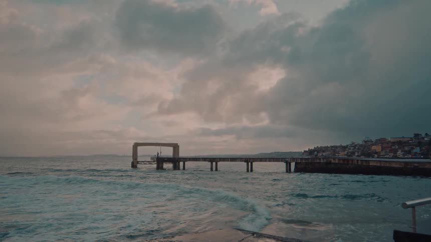Ocean waves hit the shore on a cloudy day