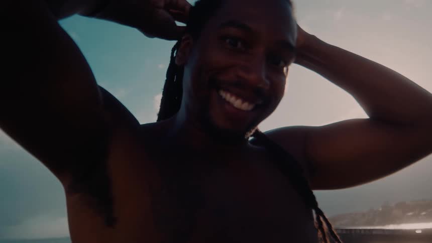 The man smiles on the beach