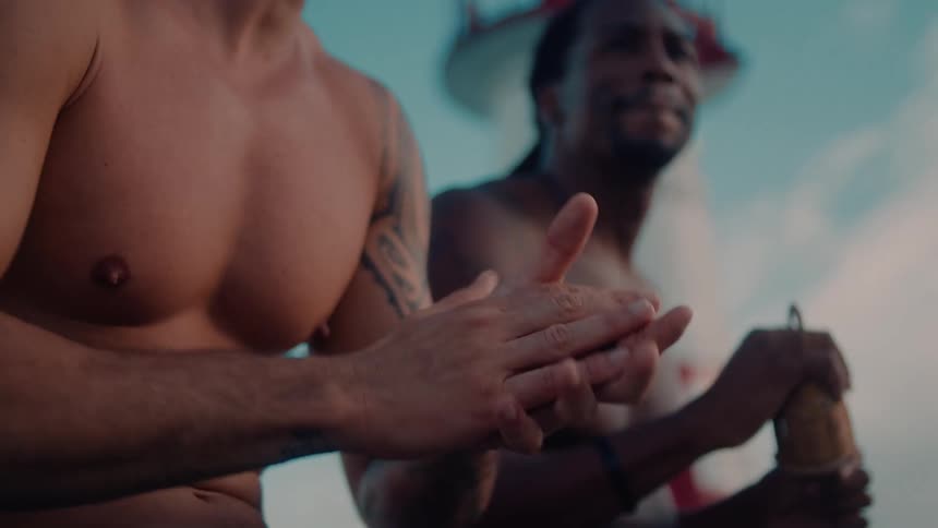 A man is clapping as another man plays music