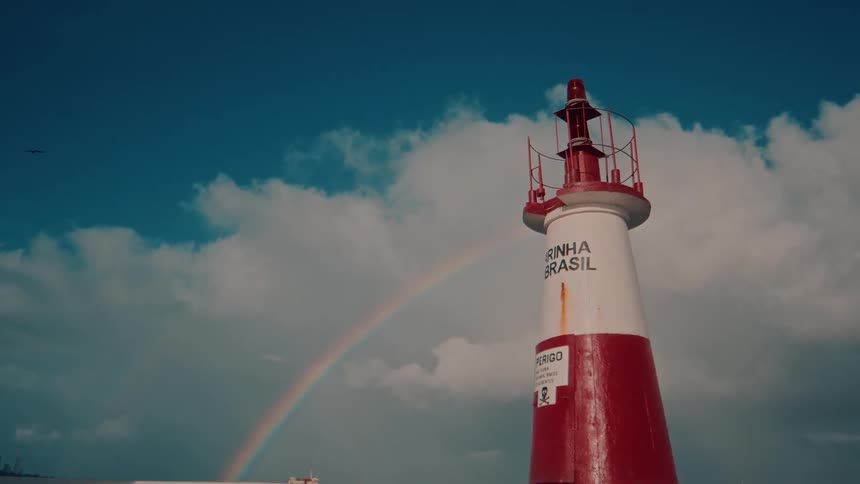 A rainbow behind a large tower
