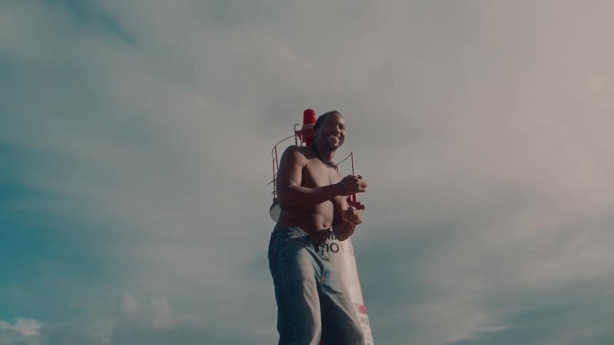 Cheerful shirtless man dancing outdoors
