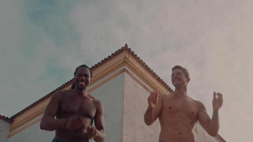 Two men are laughing and dancing